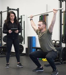 Athlete performing functional movement assessment with physical therapist at a performance physical therapy clinic in Scarborough, ME