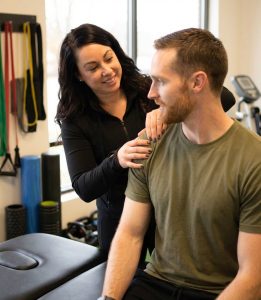 Physical therapist performing movement assessment at a sports performance clinic in Scarborough
